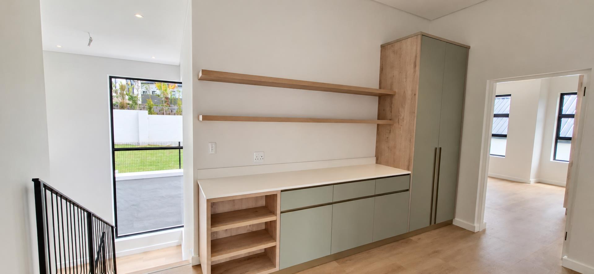 769733_Light-Filled_Minimalist_Hallway_with_Sage_Cabinetry.png